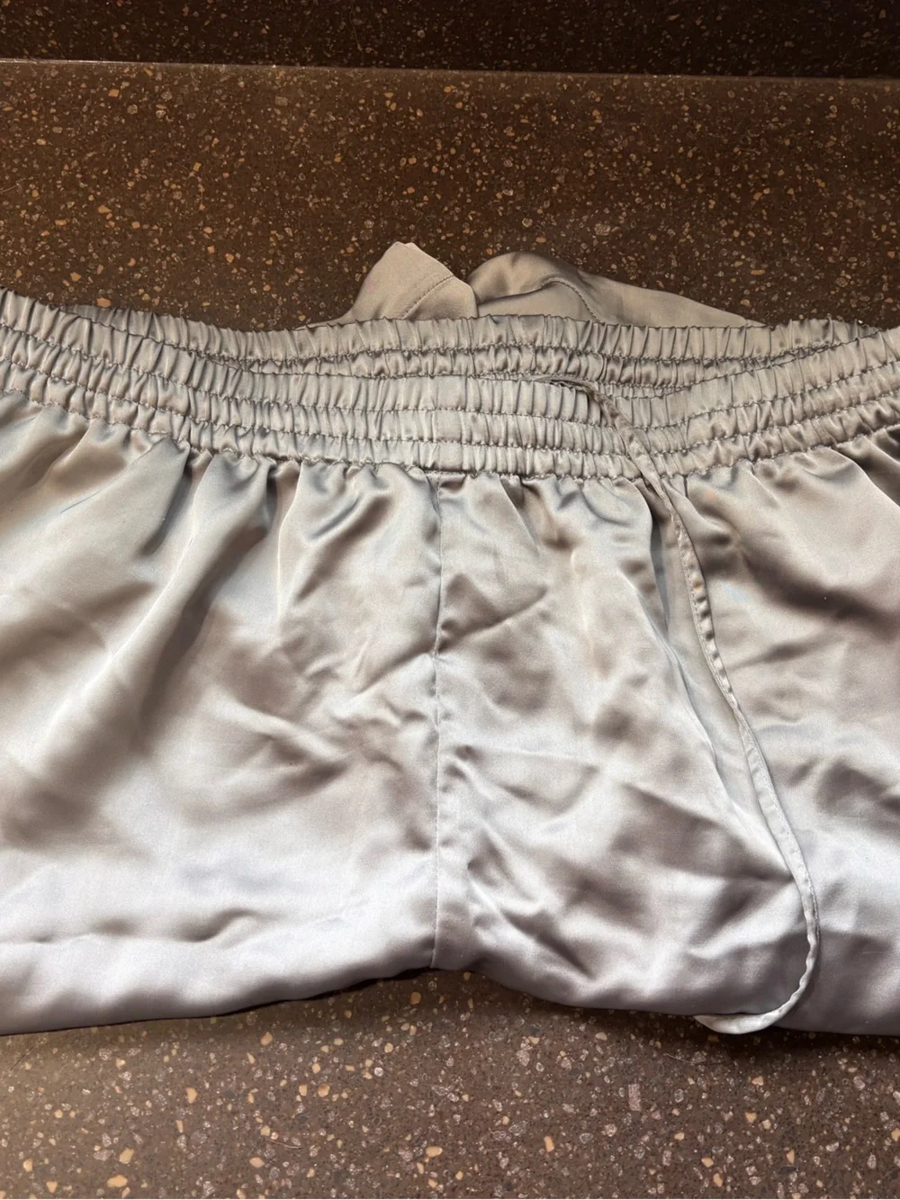 SKIMS Sporty Satin Loose Short in the metallic silver shade called Mirror
